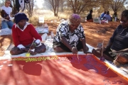 Warakurna community, WA - Tjapartji Bates, Christine West and Dorcas Bennett working on the Seven Sisters Tjukurrpa collaborative painting