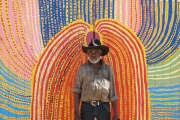 Tommy Mitchel in front of his mural painting