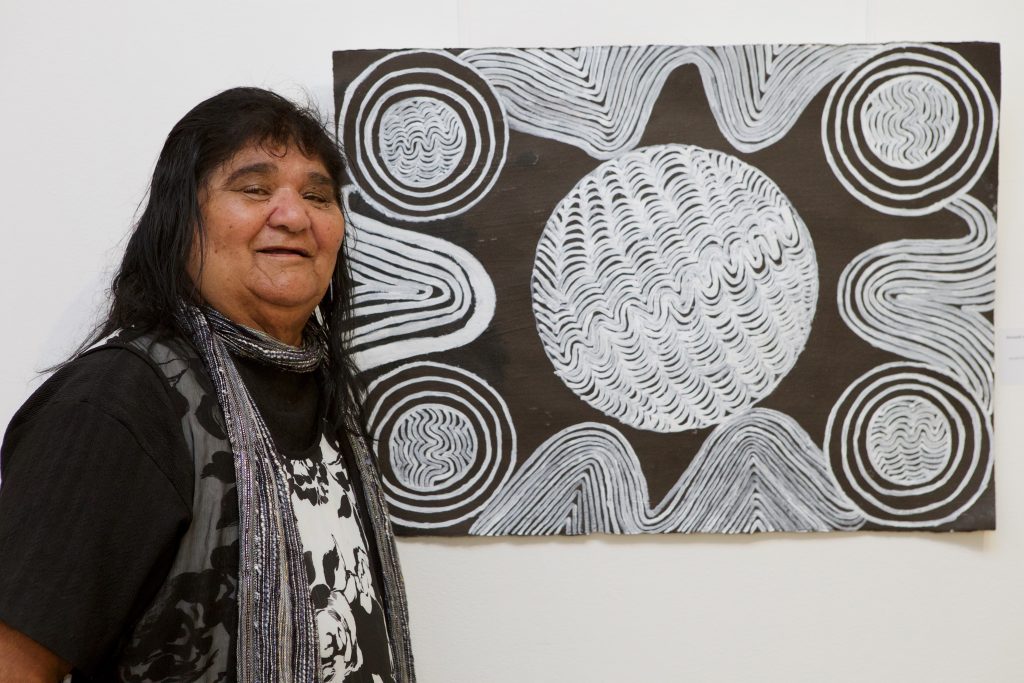 Aunty May Hinch in front of her work at Boomalli, 2015 - Courtesy Boomalli Artists - Photographer Sharon Hickey