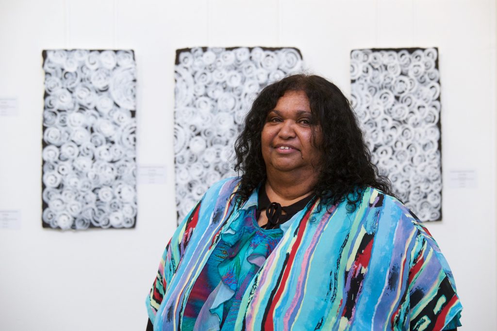 Leonie Binge in front of her work at Boomalli, 2015 - Courtesy Boomalli Artists - Photographer Sharon Hickey