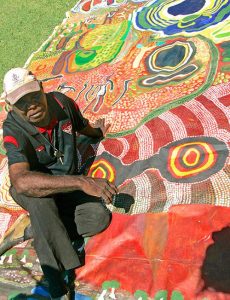 Tommy May with the Ngurrara Canvas - Photo Artlink