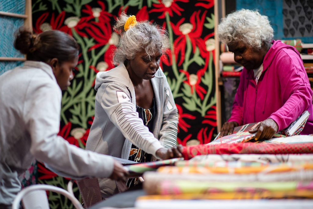 Artists Susan, Jacinta and Janet at the Babbarra Women's Centre stall for TARNANTHI 2018. Photo: Nat Rogers.