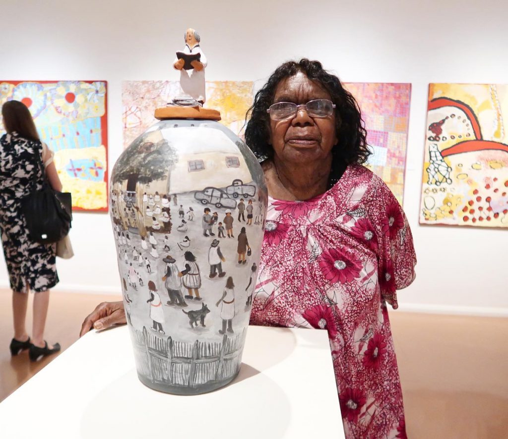 Judith Inkamala with her work part of exhibition Desert Mob 2020 - Courtesy Hermannsburg Potters